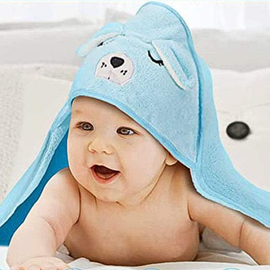 Bébé content dans sa cape de bain bébé